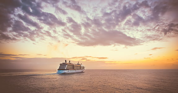 white cargo ship sailing on calm body of water under cloudy sky during daytime thumbnail