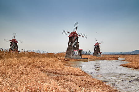 photo of watermill near river during daytime thumbnail