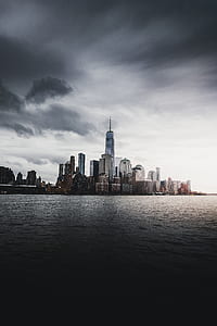 city near body of water during daytime thumbnail