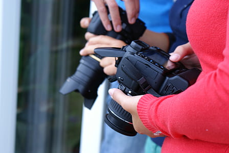 person holding DSLR camera thumbnail