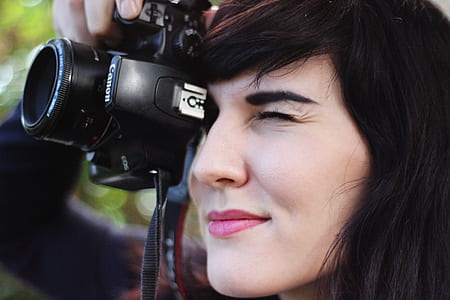 Woman Taking a Photo With Canon Dslr Camera thumbnail