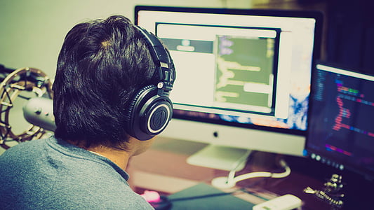 man wearing black headphones in front of computer thumbnail