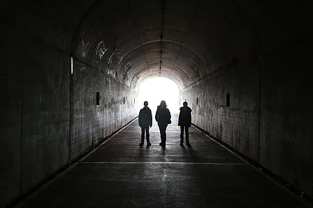 silhouette of three men standing on tunnel thumbnail