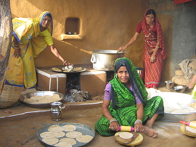 three women baking pancake near house thumbnail