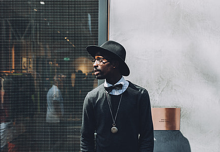 man wearing black sweater and hat thumbnail