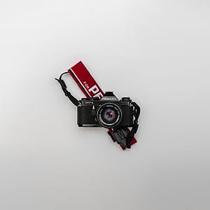 black and gray camera on white surface thumbnail