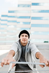 man holding gray wire thumbnail