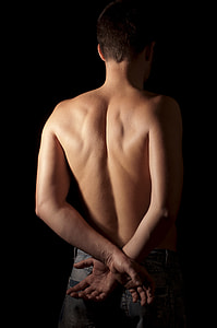 topless man showing his back and wearing gray denim bottom with both his hands cross on his back thumbnail