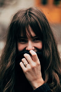 shallow focus photography of black haired woman in black sweater during day time thumbnail