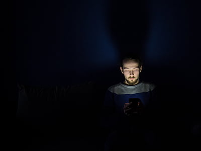 man in gray crew-neck shirt in dark room thumbnail