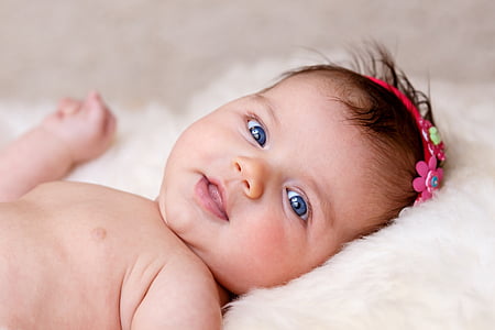 baby lying on white sofa thumbnail