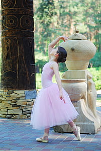 girl wearing ballerina dress posing near sculpture thumbnail