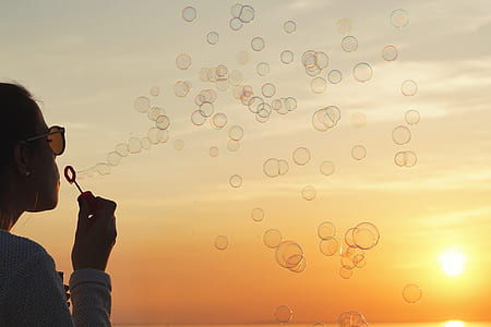 woman playing bubbles during golden hour thumbnail