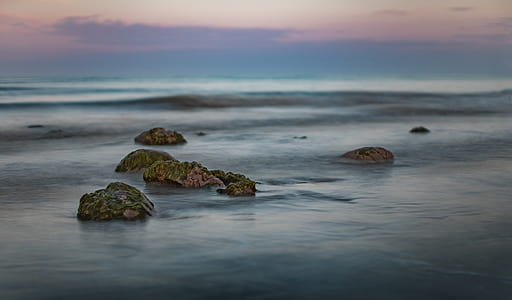 rock formation surrounded by seawater thumbnail