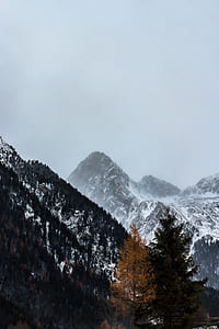 snow covered mountains under cloudy sky thumbnail