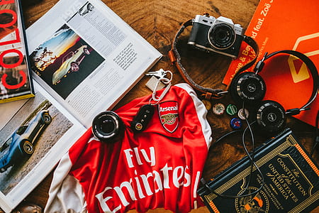 black and silver DSLR camera beside black headphones thumbnail