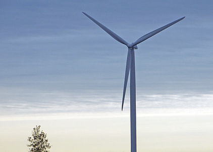 selective focus photography of white windmill under blue sky thumbnail