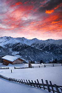 brown wooden house on snow-covered land during daytime thumbnail