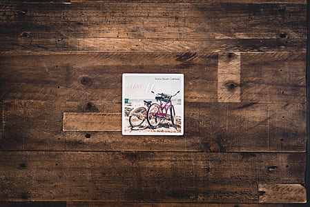 Two Assorted Bicycles Illustration on Brown Wooden Surface thumbnail