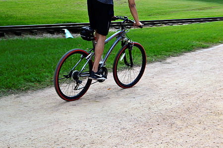 person riding bike on road thumbnail