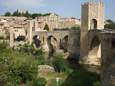 gray concrete bridge near village houses thumbnail