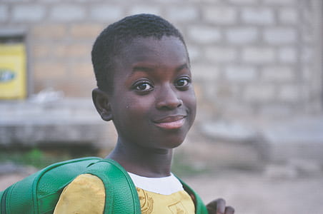 boy wearing green backpack thumbnail