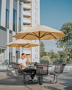 man sitting on patio table during daytime thumbnail