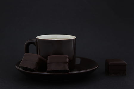 black mug on round black saucer thumbnail