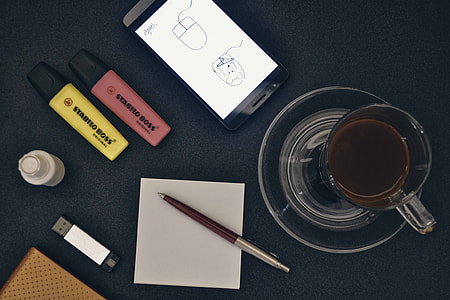 clear glass mug beside brown click pen thumbnail
