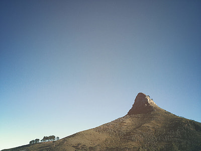 low angle photography of mountain under blue sky thumbnail