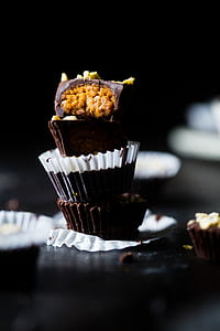 selective focus photograph of pile of three cupcakes thumbnail