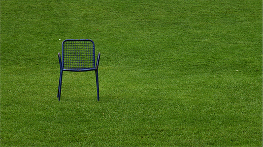 black metal armchair on grass field thumbnail