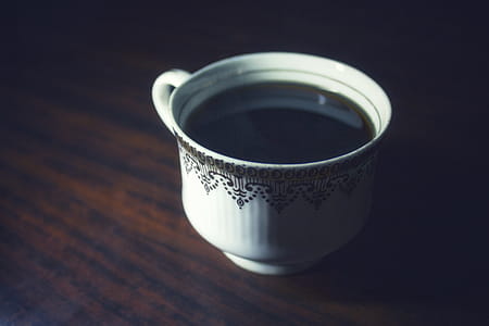 Coffee Served in White Teacup on Brown Wooden Surface thumbnail