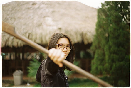 person holdiing out wooden stick outdoors thumbnail