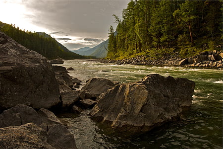 brown rock formation near river during daytime thumbnail