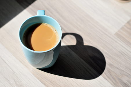 teal ceramic mug filled of coffee thumbnail