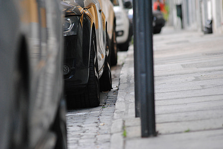 vehicles park on road during daytime thumbnail
