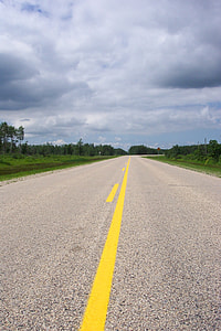 road under clouded sky at daytime thumbnail