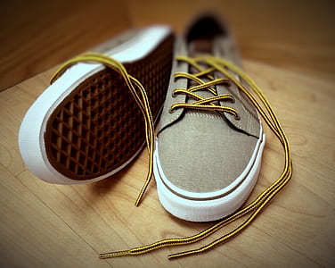 pair of brown lace-up low-top sneakers on brown surface thumbnail