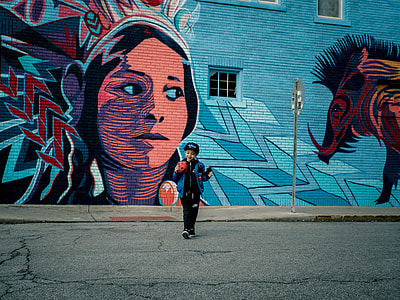 boy standing near wall artwork thumbnail