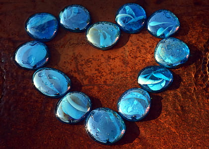 round blue stone fragments on brown surface thumbnail