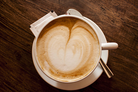 beige latte on white ceramic teacup and saucer thumbnail