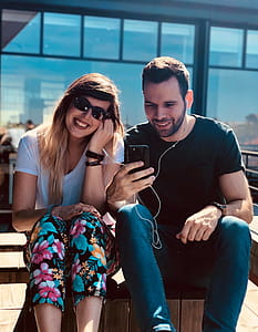 Man and Woman Using an Earphones thumbnail