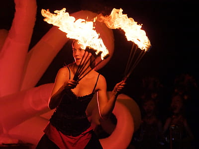 woman fire dancing during nighttime thumbnail