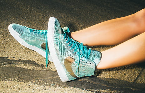 person wearing blue Nike high-top shoes thumbnail