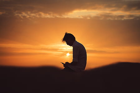 man wearing shirt against light at golden hour thumbnail