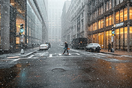 person crossing the street during daytime with rain thumbnail