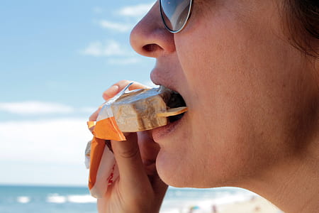 close up photography of person eating popsicle thumbnail