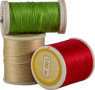three green, red, and brown sewing threads thumbnail