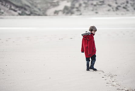 boy walking on ground covered with snow thumbnail